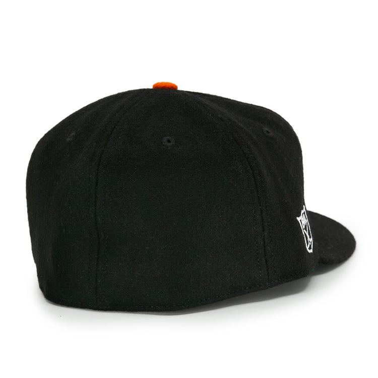 The EFF Baltimore Clippers 1962 Vintage Ballcap is a black wool cap shown from the back, with a small white Clippers logo on the right side and an orange button on top.