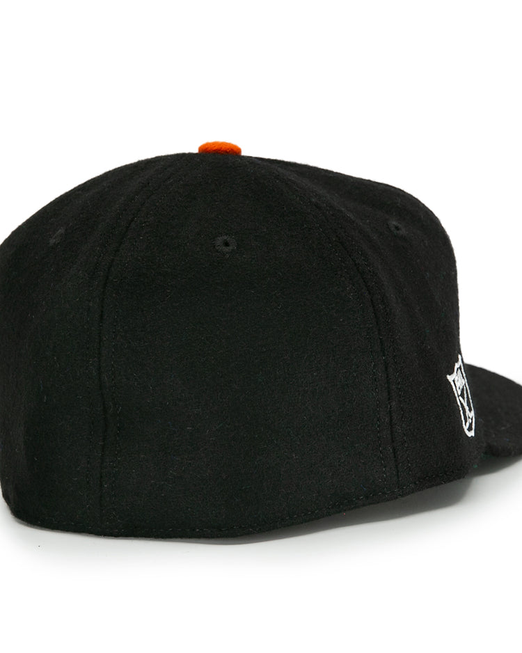The EFF Baltimore Clippers 1962 Vintage Ballcap is a black wool cap shown from the back, with a small white Clippers logo on the right side and an orange button on top.