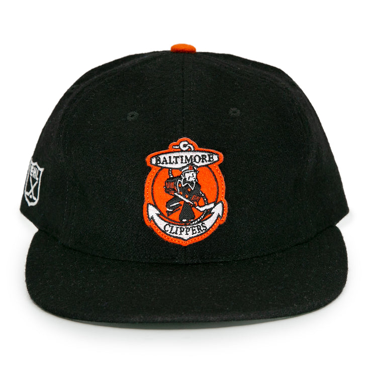 The EFF Baltimore Clippers 1962 Vintage Ballcap is a black wool hat with an orange and white logo on the front and a side patch, honoring the teams American Hockey League legacy.