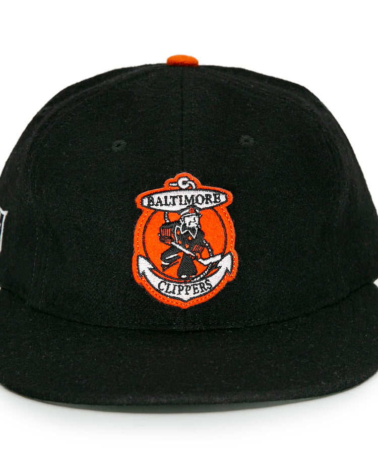 The EFF Baltimore Clippers 1962 Vintage Ballcap is a black wool hat with an orange and white logo on the front and a side patch, honoring the teams American Hockey League legacy.