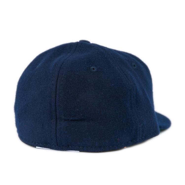 The EFF Bucknell University 1965 Vintage Ballcap features a dark blue wool design with a soft, rounded crown and flat brim. Shown from the back, it has no visible logos or designs, echoing classic vintage style.