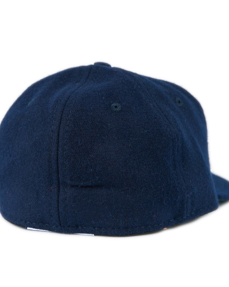 The EFF Bucknell University 1965 Vintage Ballcap features a dark blue wool design with a soft, rounded crown and flat brim. Shown from the back, it has no visible logos or designs, echoing classic vintage style.