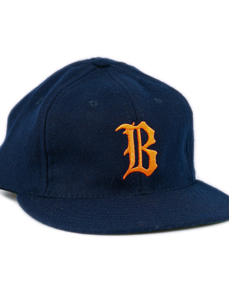 The EFF Bucknell University 1965 Vintage Ballcap is a navy wool flat-brim hat with a bold orange B on the front, made in the USA.