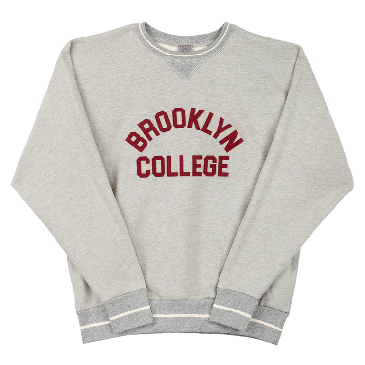 The EFF Brooklyn College Collegiate Vintage Crewneck Sweatshirt features light gray French terry fabric, bold maroon BROOKLYN COLLEGE print, and striped white/gray cuffs and hem for a timeless collegiate style.