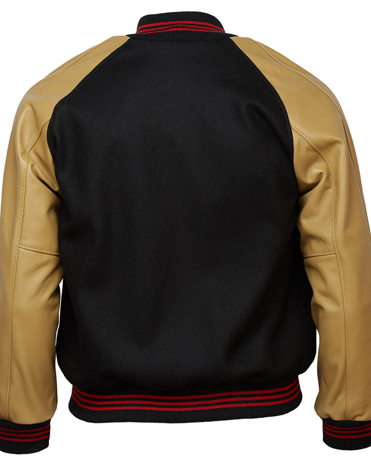 The EFF Chicago American Giants 1936 Authentic Jacket is a black Negro League varsity jacket with tan leather sleeves, black collar, and black waistband and cuffs with red stripes, shown from the back.