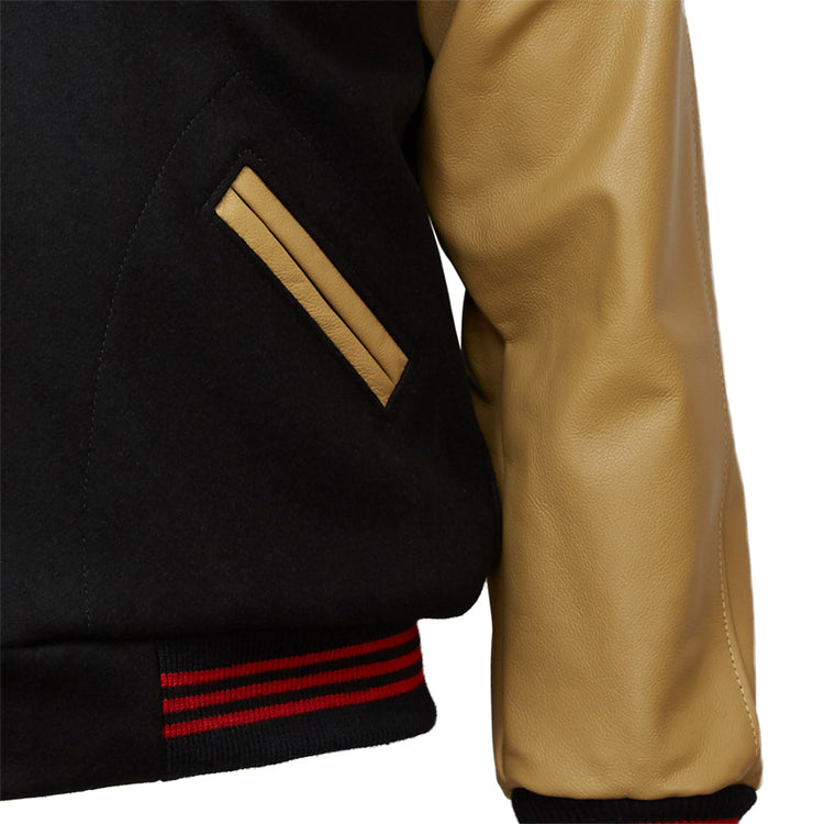 Close-up of the EFF Chicago American Giants 1936 Authentic Jacket: black body, tan leather sleeve, tan-trimmed pocket, and a black ribbed waistband with red stripes inspired by the classic 1936 style.