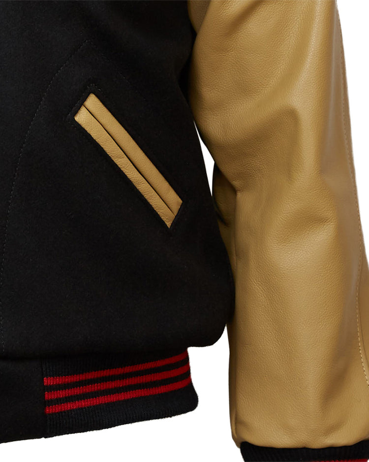 Close-up of the EFF Chicago American Giants 1936 Authentic Jacket: black body, tan leather sleeve, tan-trimmed pocket, and a black ribbed waistband with red stripes inspired by the classic 1936 style.