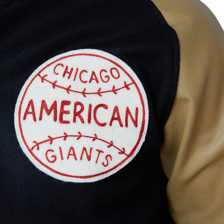 Close-up of the Chicago American Giants 1936 Authentic Jacket by EFF, featuring a red patch with baseball stitching on black and tan fabric—a tribute to the heritage of this legendary Negro League team.