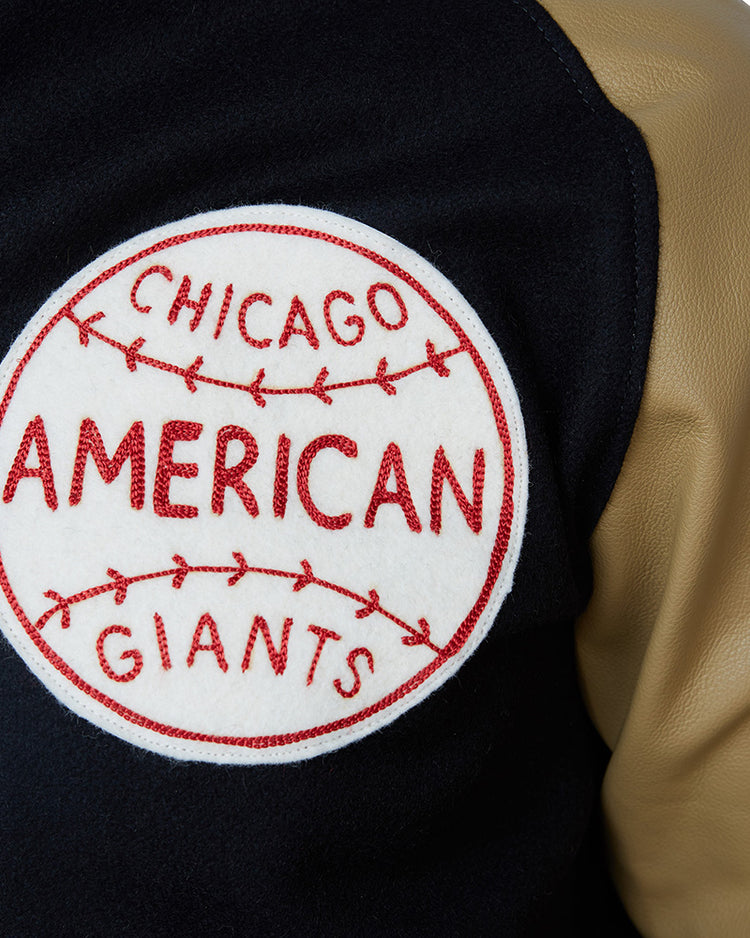 Close-up of the Chicago American Giants 1936 Authentic Jacket by EFF, featuring a red patch with baseball stitching on black and tan fabric—a tribute to the heritage of this legendary Negro League team.