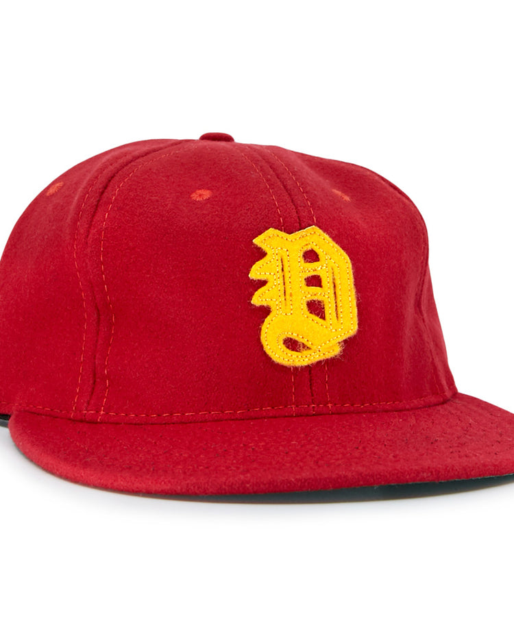 The EFF Daiei Stars 1949 Vintage Ballcap is a red, Nippon Professional Baseball-style hat with a structured crown, flat brim, and large yellow embroidered D on the front.