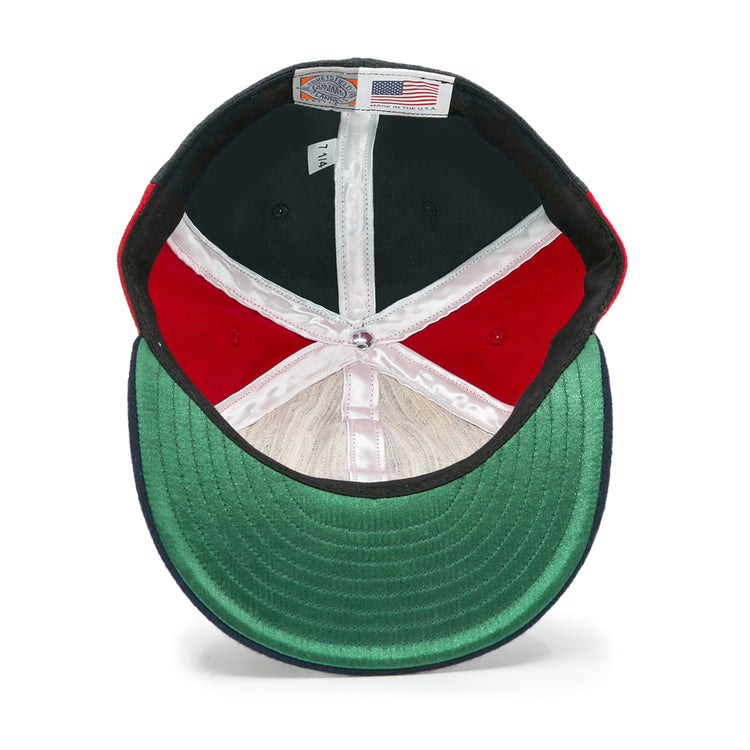 The EFF Denver Bears 1983 Vintage Ballcap features a green brim, red and black panels, white lining, and an American flag label under the crown—an authentic reproduction for vintage baseball fans.