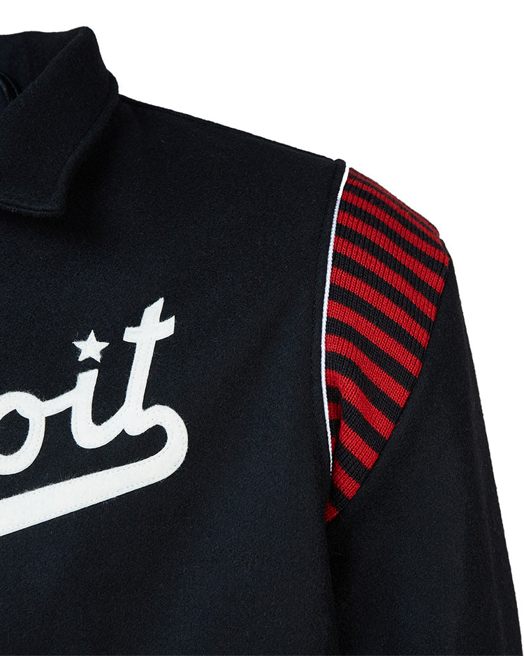Close-up of the EFF Detroit Stars 1950 Authentic Jacket, an exact reproduction featuring white script with a star dotting the i, red and black striped shoulder panel, collar, and white trim along the shoulder seam.