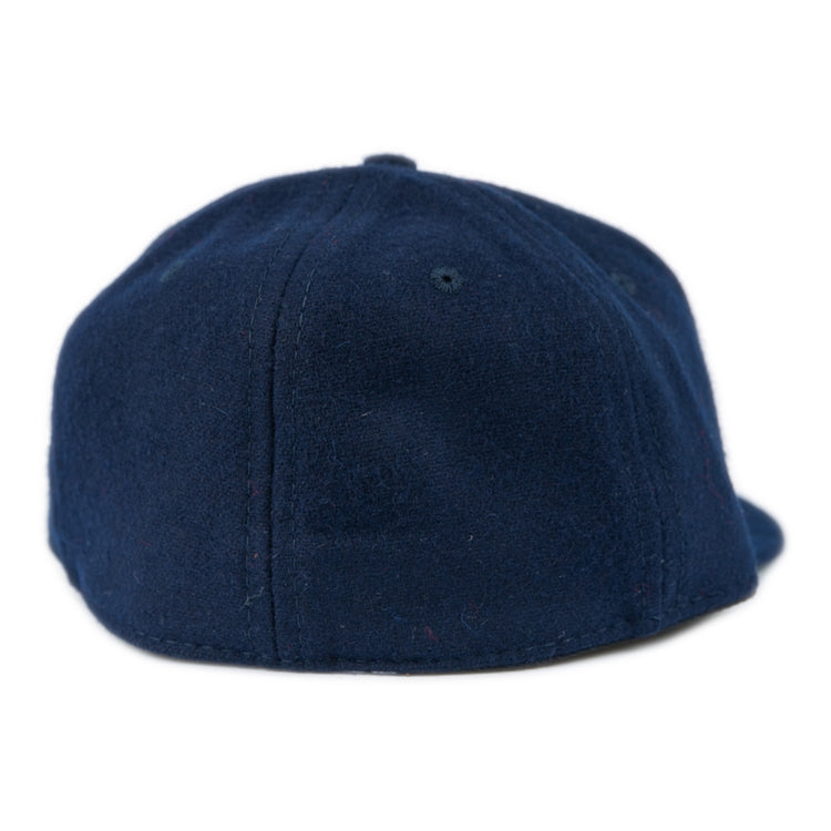 The Ebbets Field Flannels University of Mississippi 1969 Vintage Ballcap features classic navy blue wool with visible stitching and a top button, inspired by the Ole Miss Rebels historic style.