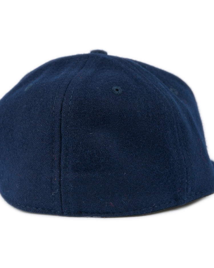 The Ebbets Field Flannels University of Mississippi 1969 Vintage Ballcap features classic navy blue wool with visible stitching and a top button, inspired by the Ole Miss Rebels historic style.