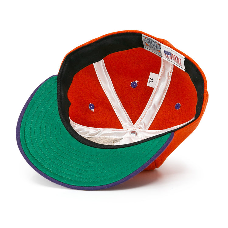 The Hershey Sport Club 1956 Vintage Ballcap by Ebbets Field Flannels has a green brim, white lining, and purple trim under the bill. Inside are a size tag and American flag label, showcasing its authentic wool baseball cloth construction.
