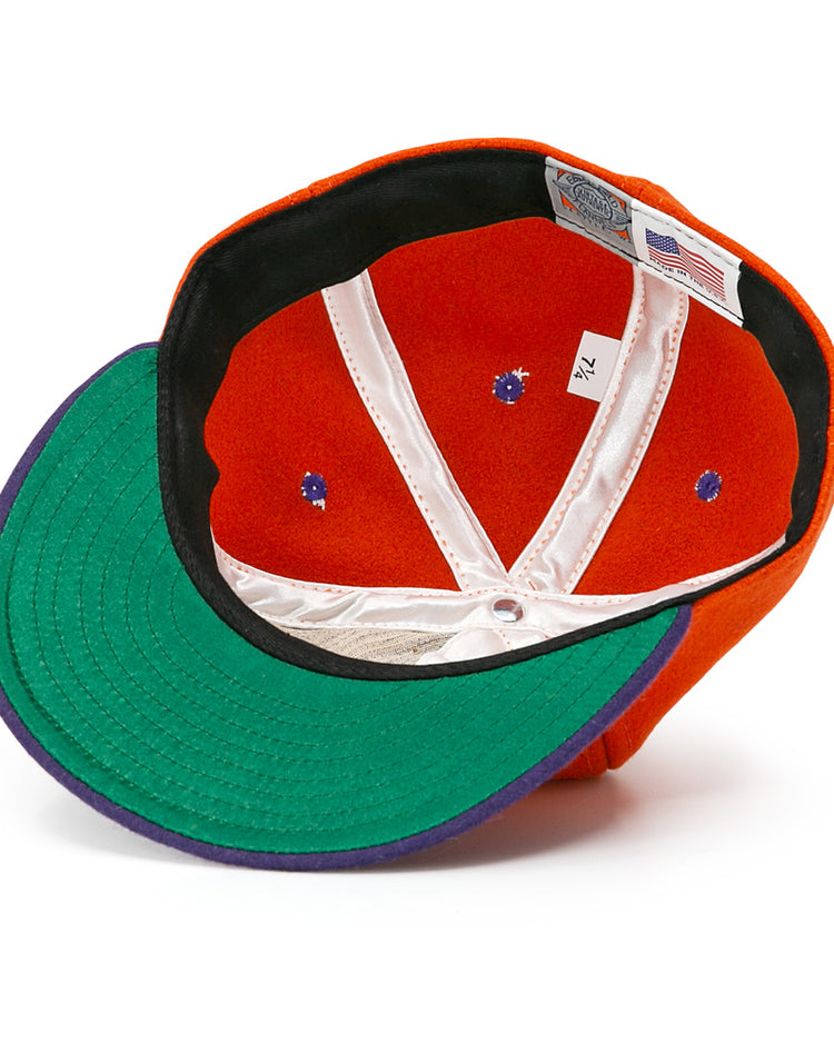 The Hershey Sport Club 1956 Vintage Ballcap by Ebbets Field Flannels has a green brim, white lining, and purple trim under the bill. Inside are a size tag and American flag label, showcasing its authentic wool baseball cloth construction.