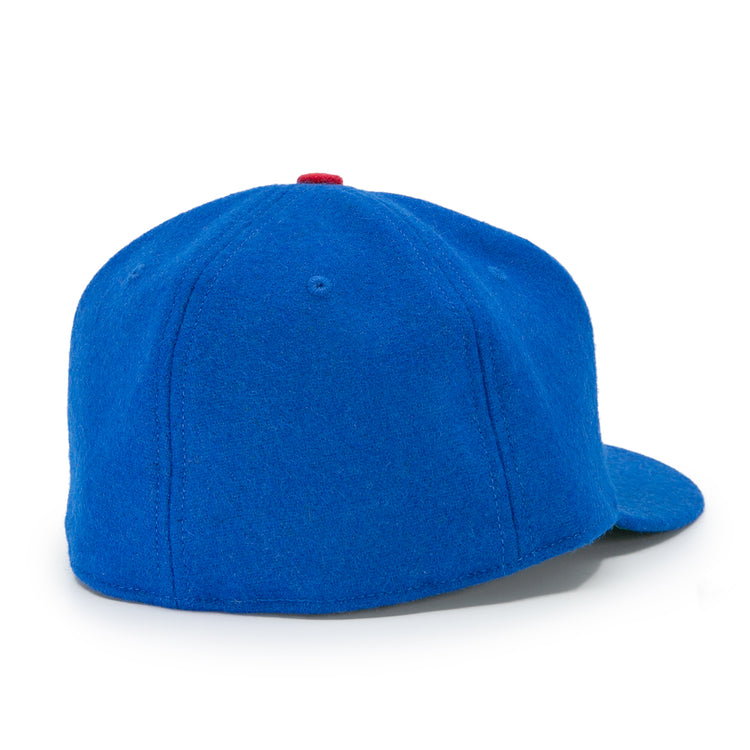 The Houston Buffs 1960 Vintage Ballcap by EFF is a bright blue wool cap with a rounded crown, flat brim, small red top button, and no logos or adjustment straps, viewed from the back.