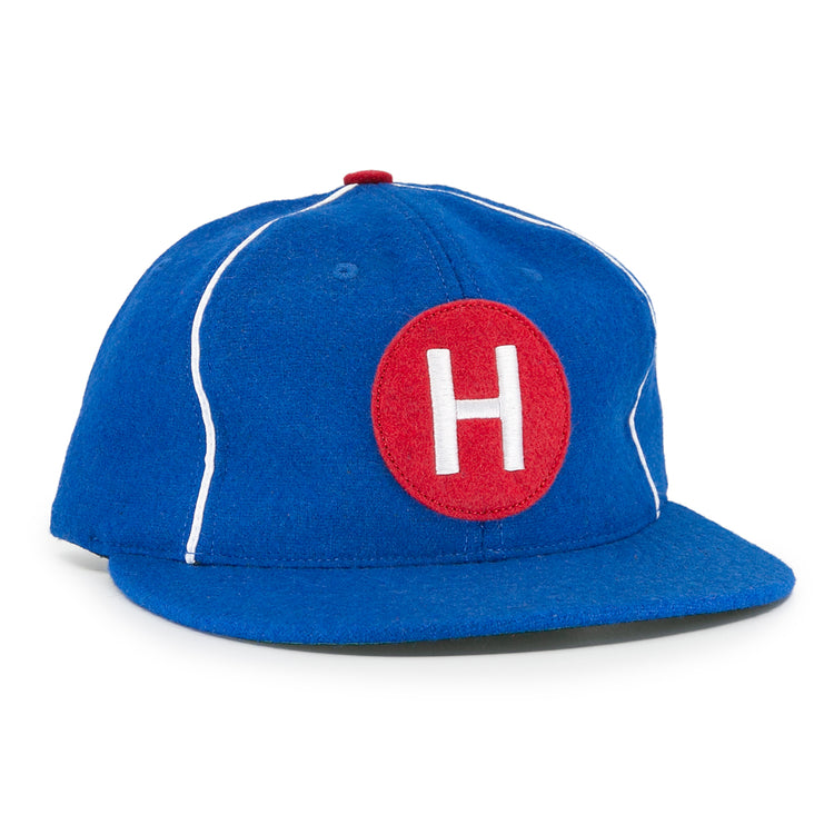 The EFF Houston Buffs 1960 Vintage Ballcap features blue wool baseball cloth, white piping, a red top button, and a front red patch with a white H—authentic to the classic 1960 team style.