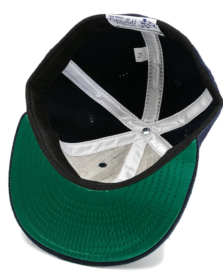 The EFF Howard University 1960 Vintage Ballcap features a green underbrim, white stitched seams, a white size 7 1/4 tag, and a black sweatband lining the inside.