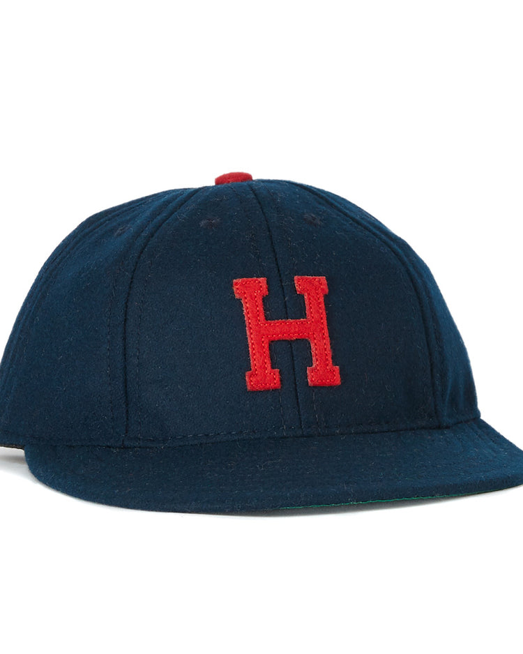 The EFF Houston Buffs 1932 Vintage 8-Panel Ballcap is a navy wool cap featuring a red embroidered H on the front and a red top button, inspired by the classic 1932 design.