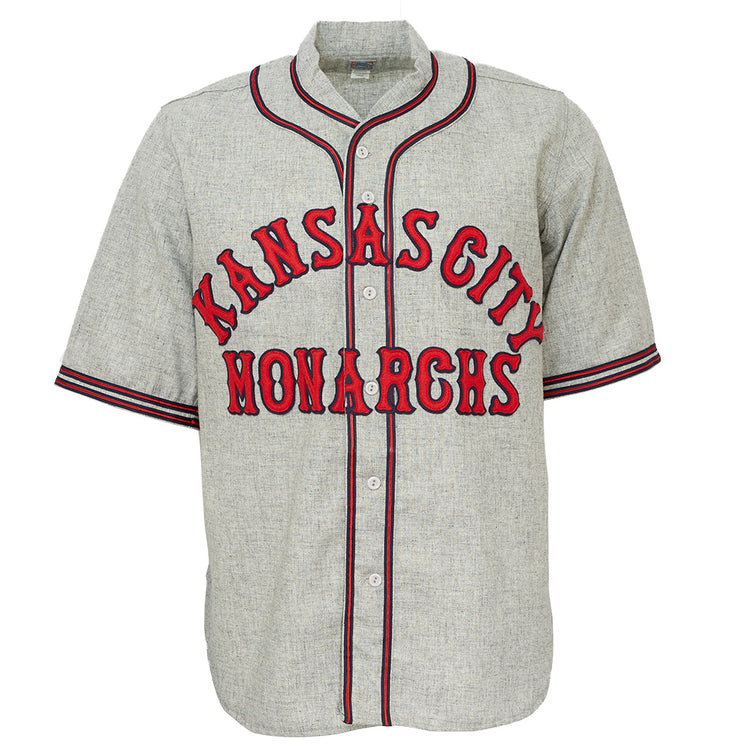 The EFF Kansas City Monarchs 1936 Road Jersey is a gray vintage-style baseball flannel with red and black trim, featuring bold KANSAS CITY above MONARCHS, inspired by classic Negro Leagues jerseys.