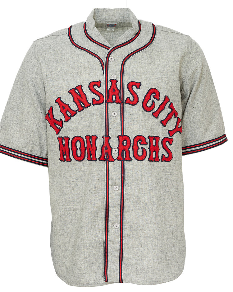 The EFF Kansas City Monarchs 1936 Road Jersey is a gray vintage-style baseball flannel with red and black trim, featuring bold KANSAS CITY above MONARCHS, inspired by classic Negro Leagues jerseys.