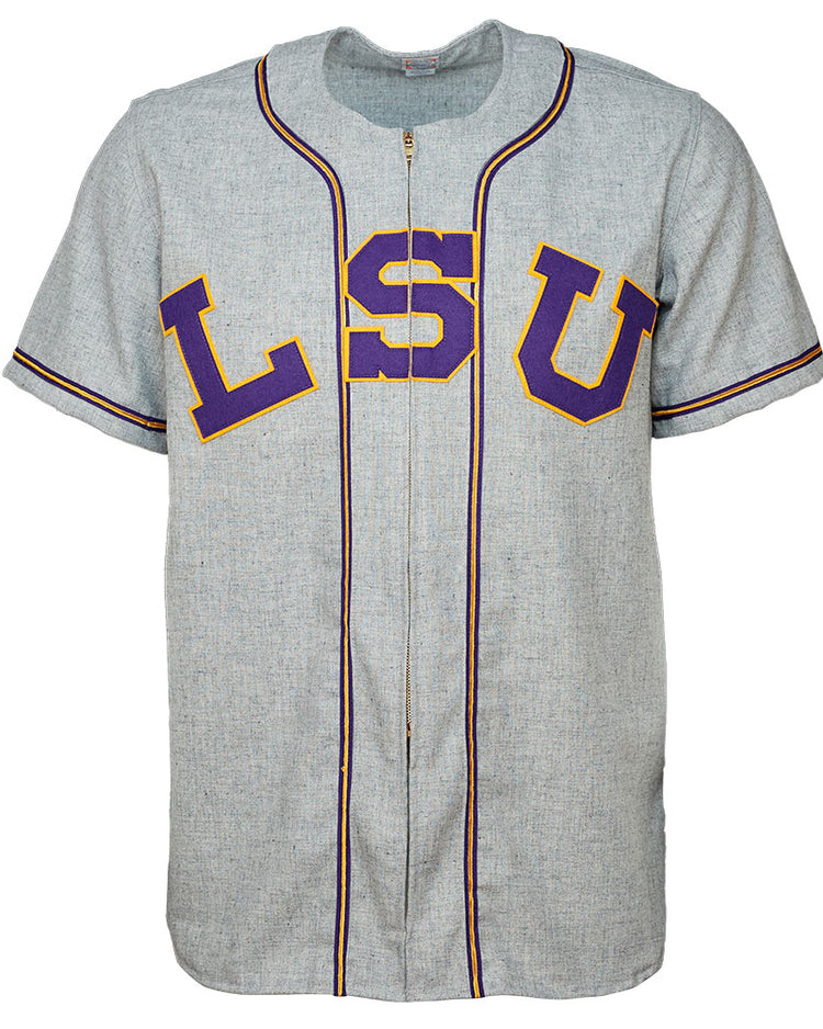 The EFF Louisiana State University 1954 Home Jersey is a gray short-sleeve baseball jersey with purple and gold lettering, black-trimmed piping, and an authentic design inspired by College World Series champions.