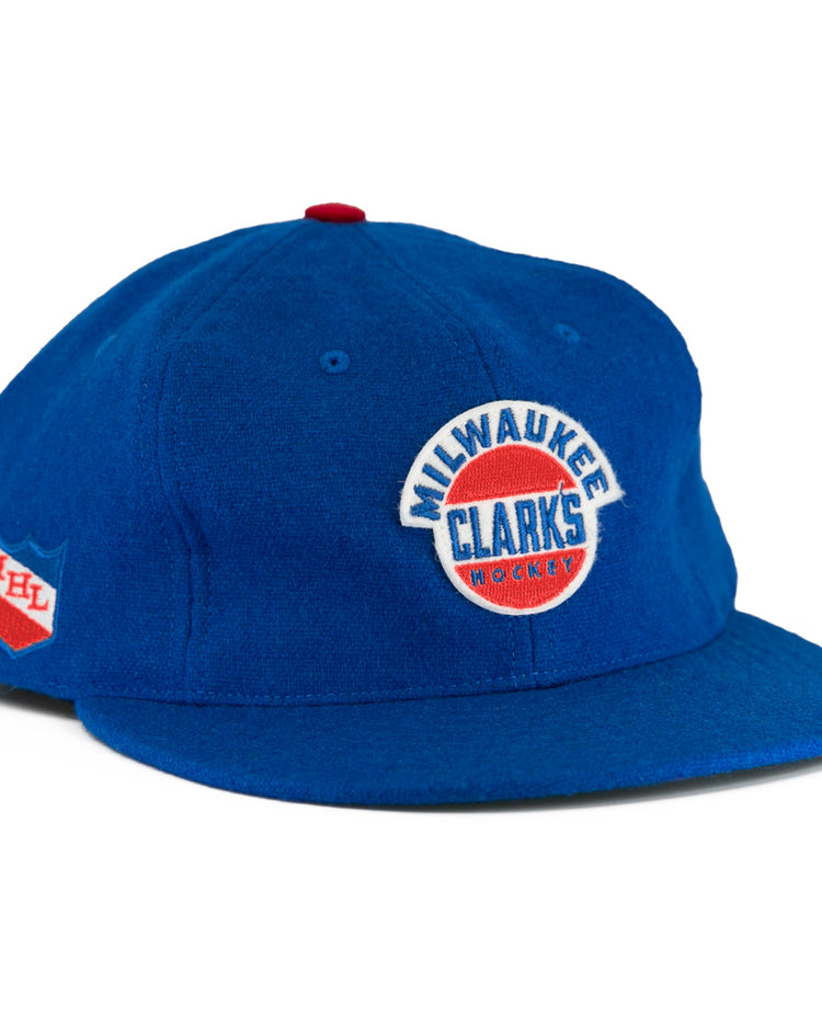 The EFF Milwaukee Clarks Vintage Ballcap is a blue wool cap with Milwaukee Clarks Hockey embroidered on the front and an IHL patch on the side—ideal for hockey fans and collectors.