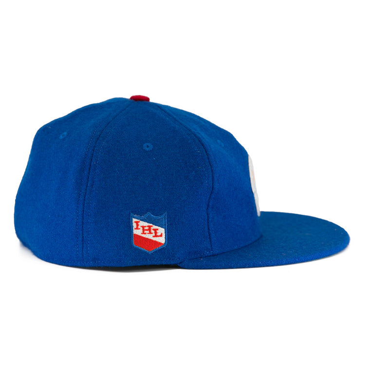 The Milwaukee Clarks Vintage Ballcap by EFF is a blue wool cap with a flat brim, featuring the International Hockey Leagues red and white shield logo on the side panel.