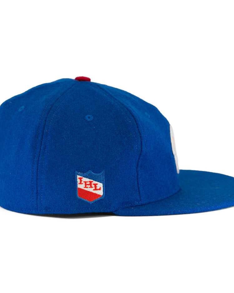 The Milwaukee Clarks Vintage Ballcap by EFF is a blue wool cap with a flat brim, featuring the International Hockey Leagues red and white shield logo on the side panel.