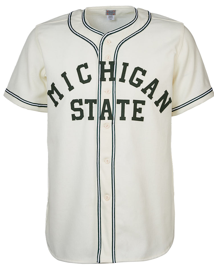 The EFF Michigan State 1940 Home Jersey is a white baseball jersey with black trim, front buttons, and MICHIGAN STATE in large dark green letters across the chest for a vintage collegiate look.