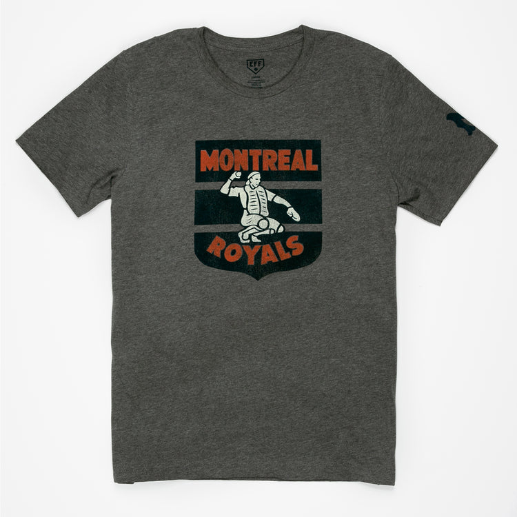 The EFF Montreal Royals 1946 T-Shirt is heather gray with a vintage-style catcher logo in white and orange on the chest, celebrating Dodgers prospect history, plus a small dark graphic on the left sleeve.