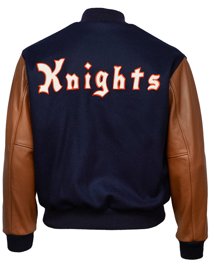The EFF New York Knights 1939 Authentic Jacket features brown leather sleeves and a navy blue melton wool back with Knights boldly displayed in large orange and white letters across the back.