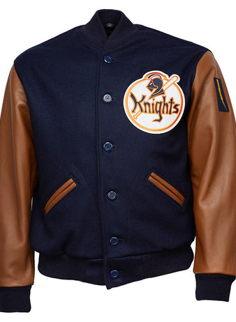 The EFF New York Knights 1939 Authentic Jacket features navy melton wool, brown leather sleeves, front pockets, a large Knights patch on the left chest, button-up front, and ribbed cuffs and waistband for a classic varsity look.