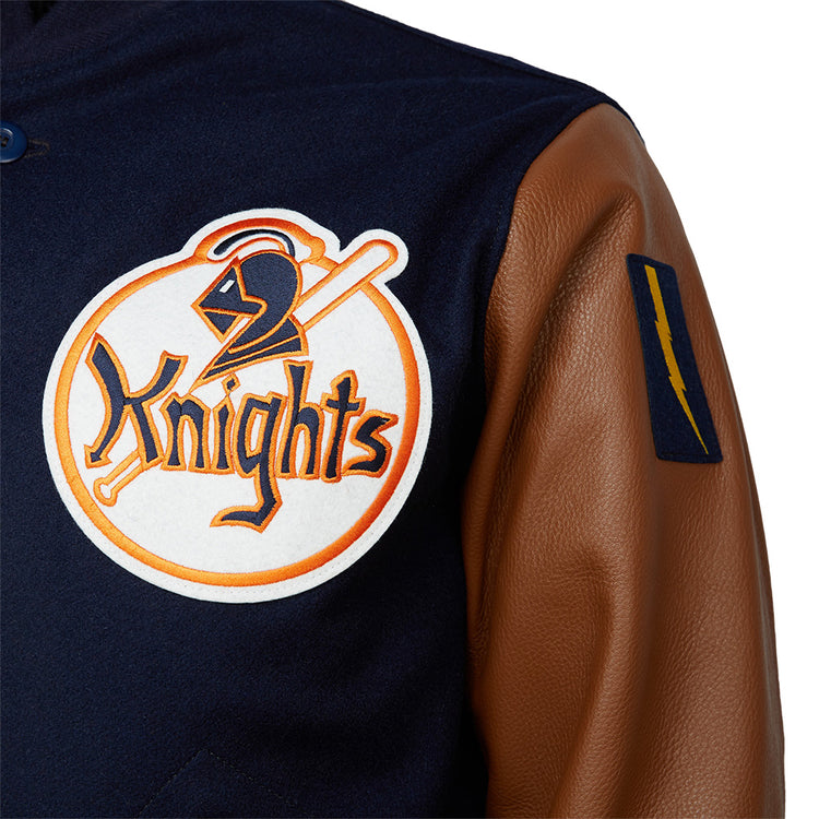 A close-up of the EFF New York Knights 1939 Authentic Jacket, crafted from melton wool with brown leather sleeves, featuring a large chest patch of a knight’s helmet and bat, plus a blue patch with a yellow lightning bolt on the sleeve.