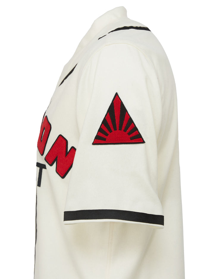 The EFF Nippon Giants 1938 Home Jersey is a vintage-style white jersey with black trim, bold red and black front text, and a red rising sun patch in a triangle on the left sleeve, inspired by classic Japanese baseball.