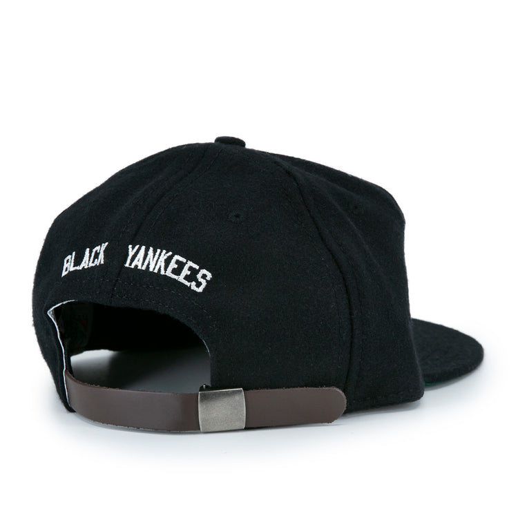 The EFF New York Black Yankees Vintage Inspired Ballcap features BLACK YANKEES embroidered in white above an adjustable brown leather strap and silver buckle, designed in classic genuine wool ballcap style.