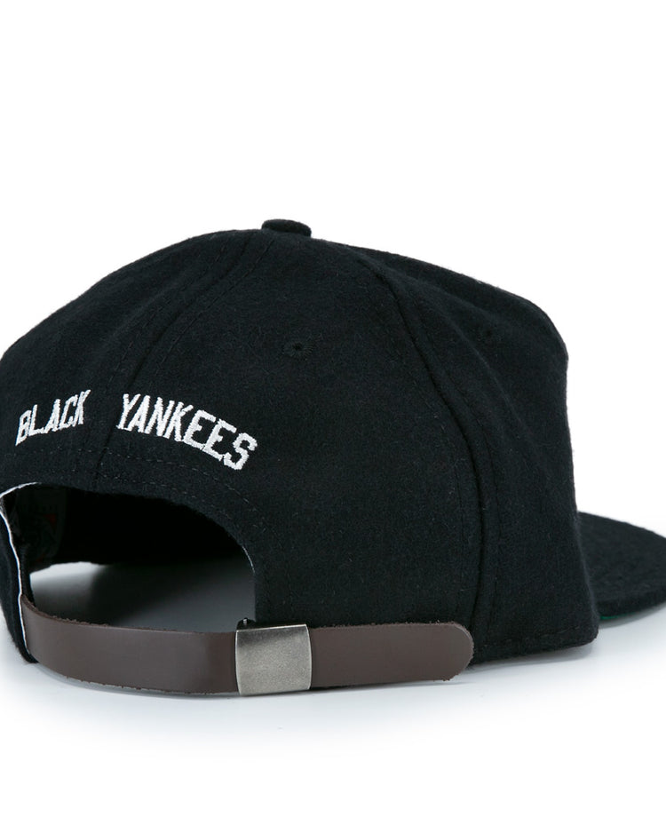 The EFF New York Black Yankees Vintage Inspired Ballcap features BLACK YANKEES embroidered in white above an adjustable brown leather strap and silver buckle, designed in classic genuine wool ballcap style.