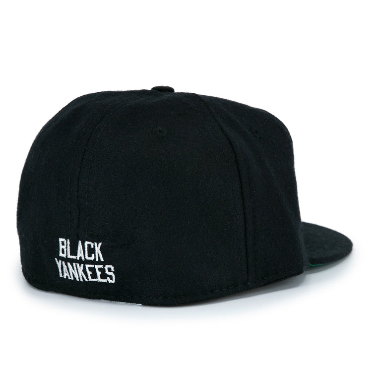 The EFF New York Black Yankees Vintage Inspired Ballcap is a classic black wool hat, seen from the back with BLACK YANKEES embroidered in white near the bottom edge—true vintage baseball style.