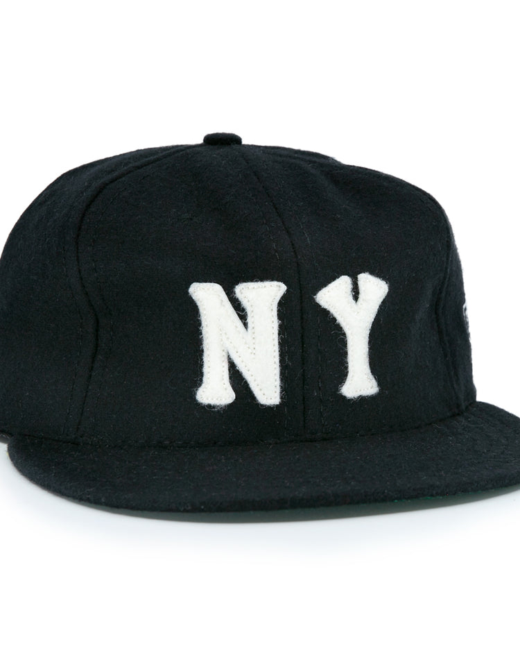The EFF New York Black Yankees Vintage Inspired Ballcap is a black hat featuring bold white NY letters on the front, offering a classic vintage look.