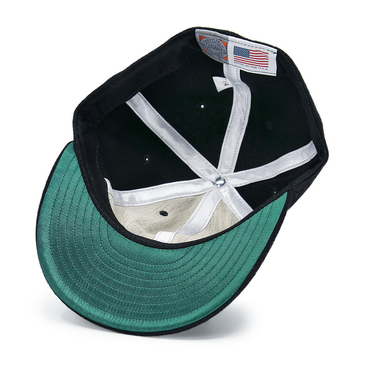 Inside the New York Black Yankees Vintage Inspired Ballcap by EFF: a green underbrim, black fabric, white sweatband, and a label with an American flag and Made in the USA text.