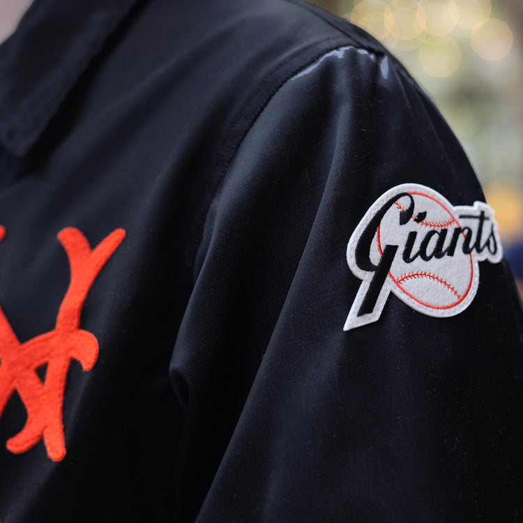 EFF’s New York Giants 1954 Satin Windbreaker features a bold orange “NY” chest logo and a white “Giants” baseball patch on the sleeve, channeling true vintage MLB style.