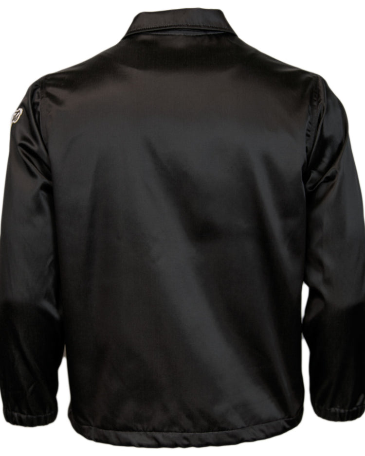 The EFF New York Giants 1954 Satin Windbreaker is a black, long-sleeve baseball jacket with shiny satin fabric, elastic waistband and cuffs, plus a small white logo on the upper right sleeve—ideal for MLB vintage style.