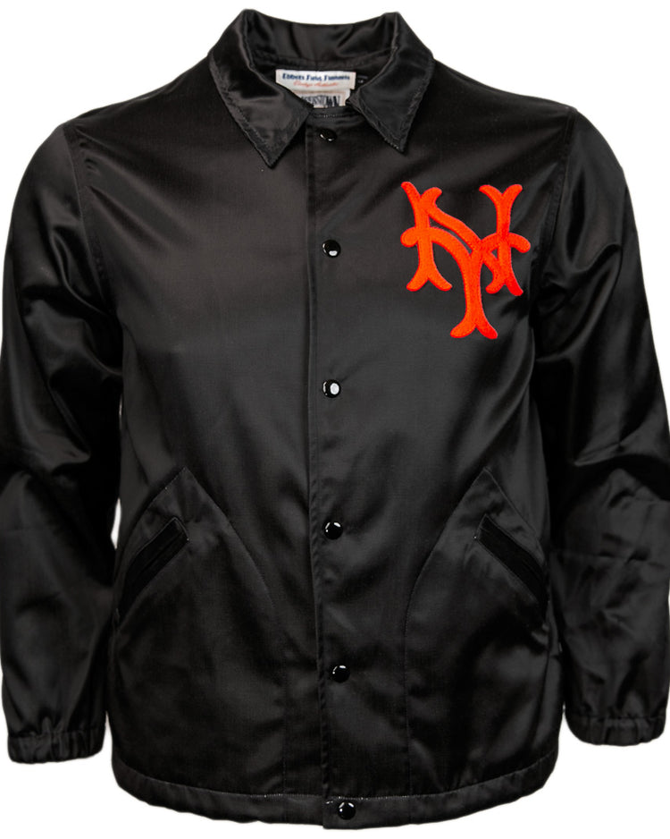 The EFF New York Giants 1954 Satin Windbreaker is a black vintage-style baseball jacket with pockets and a bold red interlocking NY logo on the left chest.