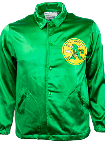 The EFF Oakland As 1971 Satin Windbreaker features bright green satin, snap buttons, side pockets, and a circular yellow patch with The Swingin’ A’s logo on the chest—perfect for fans of MLB vintage style.