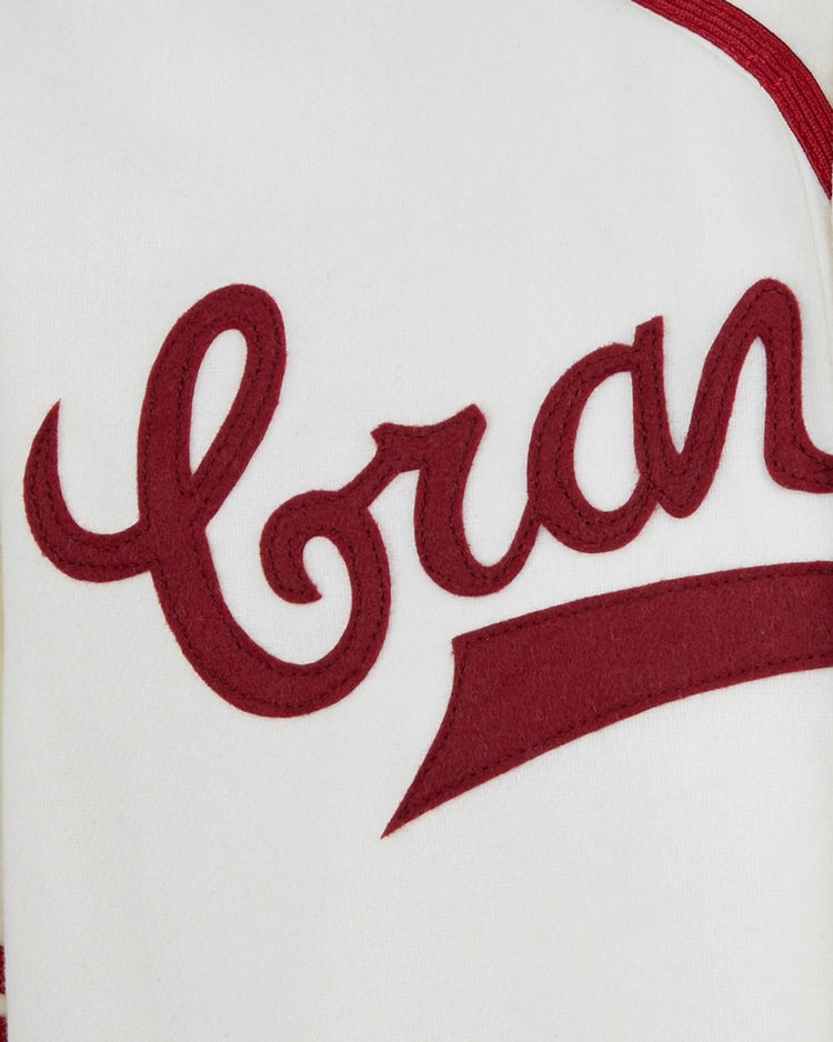 Close-up of an EFF Pittsburgh Crawfords 1944 Home Jersey, an authentic cream-colored sports jersey with red cursive “Braves” lettering and red trim, inspired by the classic Pittsburgh Crawfords style.
