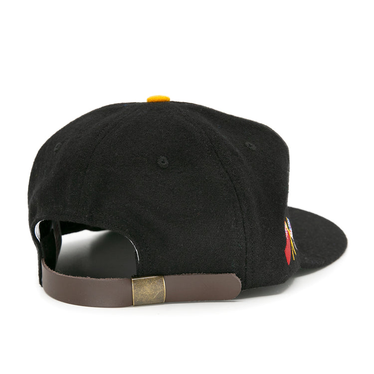 The Pittsburgh Hornets 1953 Vintage Ballcap by EFF is a black wool hat seen from the back, featuring a brown adjustable leather strap with brass buckle and a small side embroidered logo—classic vintage hockey style.