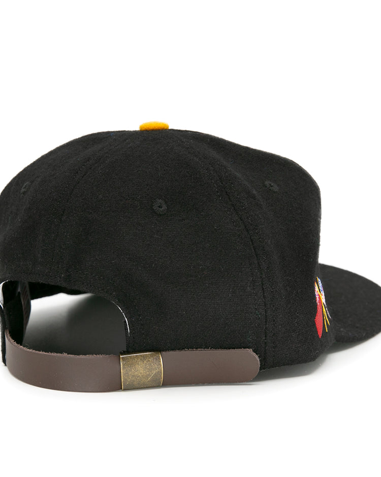The Pittsburgh Hornets 1953 Vintage Ballcap by EFF is a black wool hat seen from the back, featuring a brown adjustable leather strap with brass buckle and a small side embroidered logo—classic vintage hockey style.