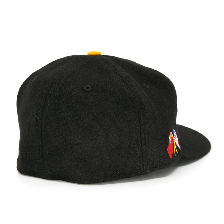 The EFF Pittsburgh Hornets 1953 Vintage Ballcap is a black wool hat with a flat brim, yellow top button, and a small colorful embroidered design on the back, inspired by vintage hockey style.
