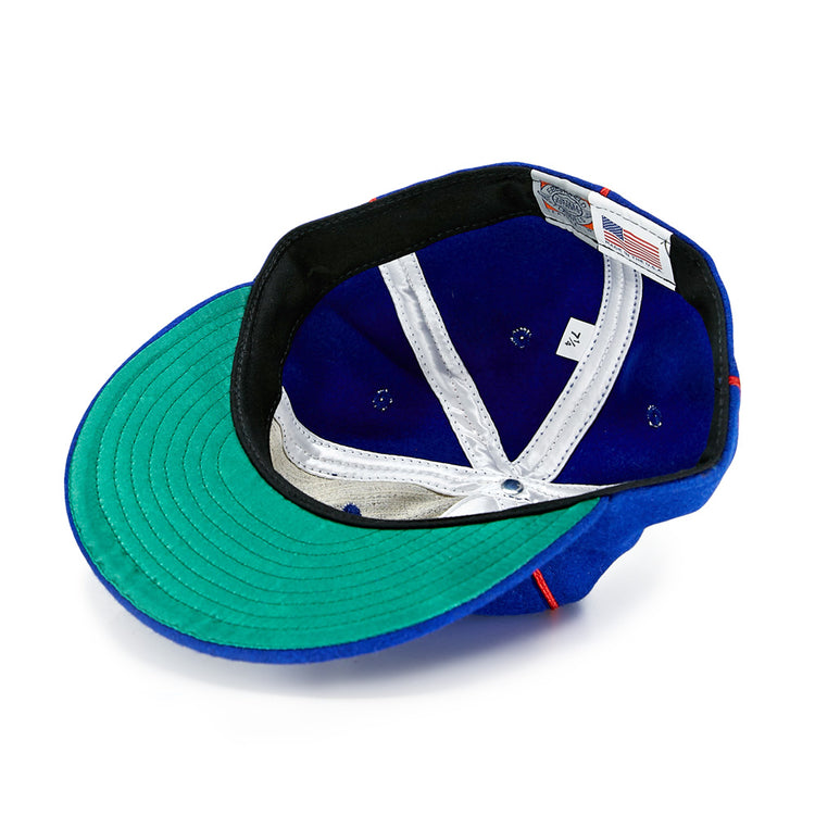 The EFF Phoenix Senators 1930 Vintage Ballcap in blue wool is shown inside out, displaying its green brim underside, white lining, black sweatband, size tag, and Made in USA label—true to the original Arizona State League style.
